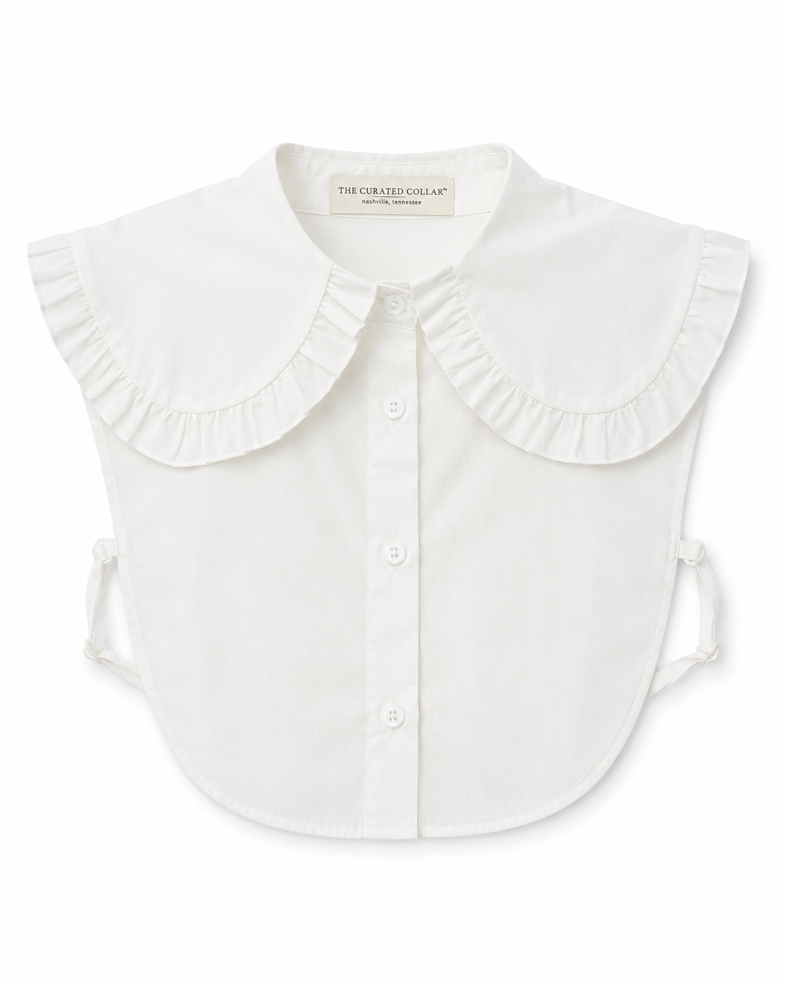 White blouse dickey with ruffled collar design on a white background with tag The Curated Collar visible